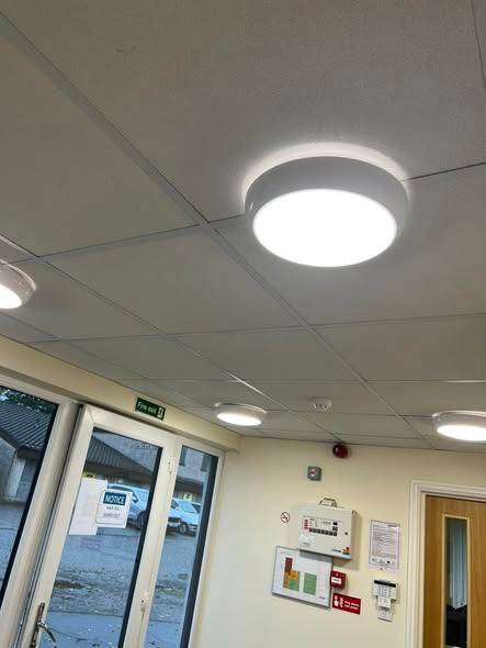 Round LED ceiling light installed in a suspended ceiling.