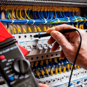 Electrician testing an electrical consumer unit and circuit connections.